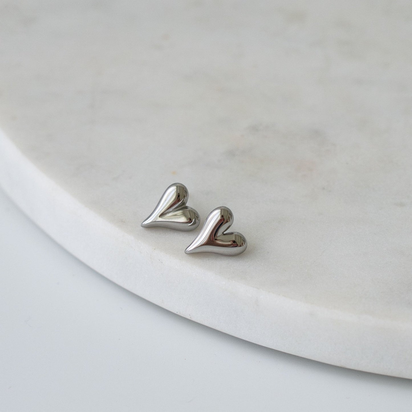 Heart-shaped stud earrings in gold and silver finishes, a timeless and meaningful gift for any occasion.