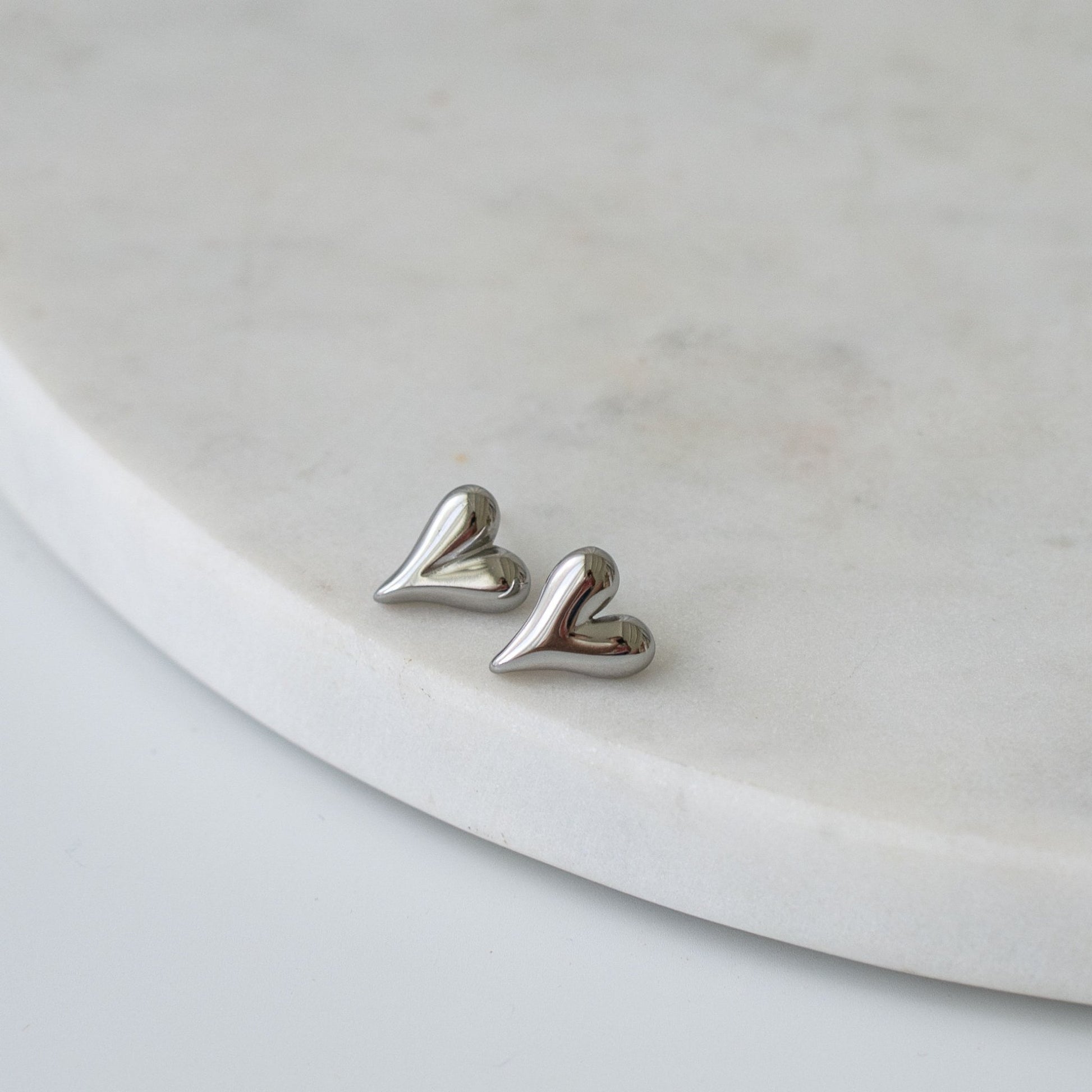 Heart-shaped stud earrings in gold and silver finishes, a timeless and meaningful gift for any occasion.