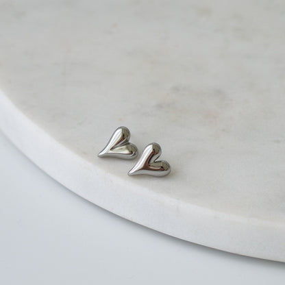 Heart-shaped stud earrings in gold and silver finishes, a timeless and meaningful gift for any occasion.